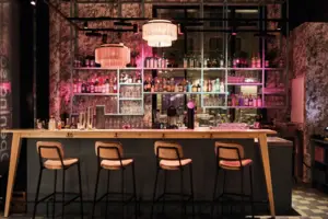 Bar Eine Bar mit einer Reihe von Hockern und Lichtern.